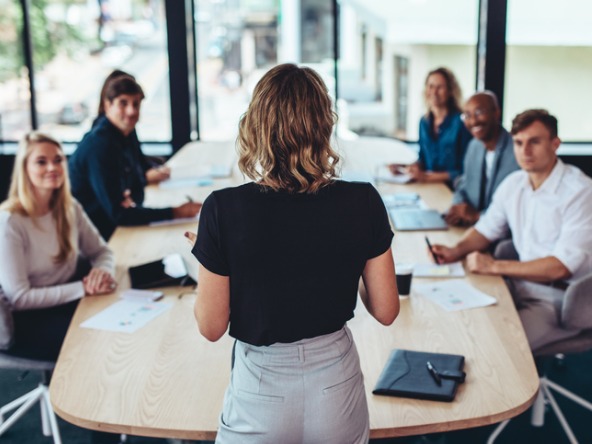 female business leader addressing a group of employees